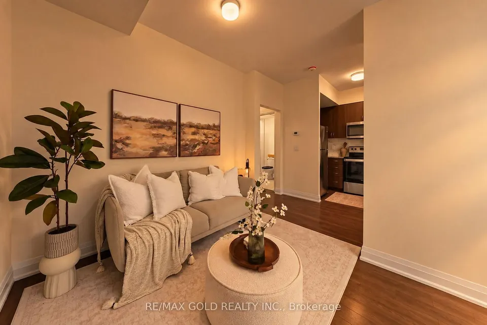 Living room with a cream sofa and a view to the kitchen