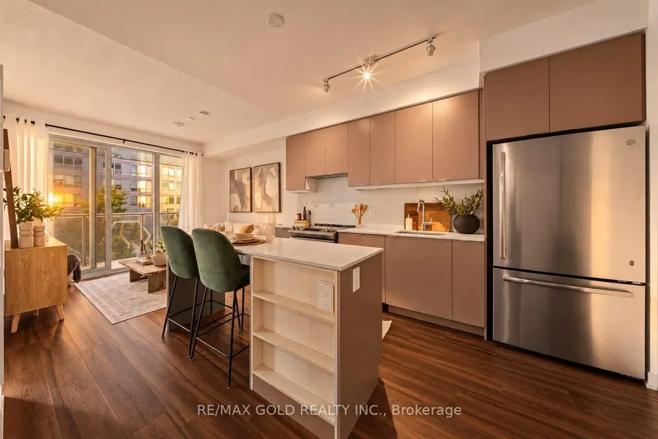Kitchen with stainless appliances and an island, open to the living room