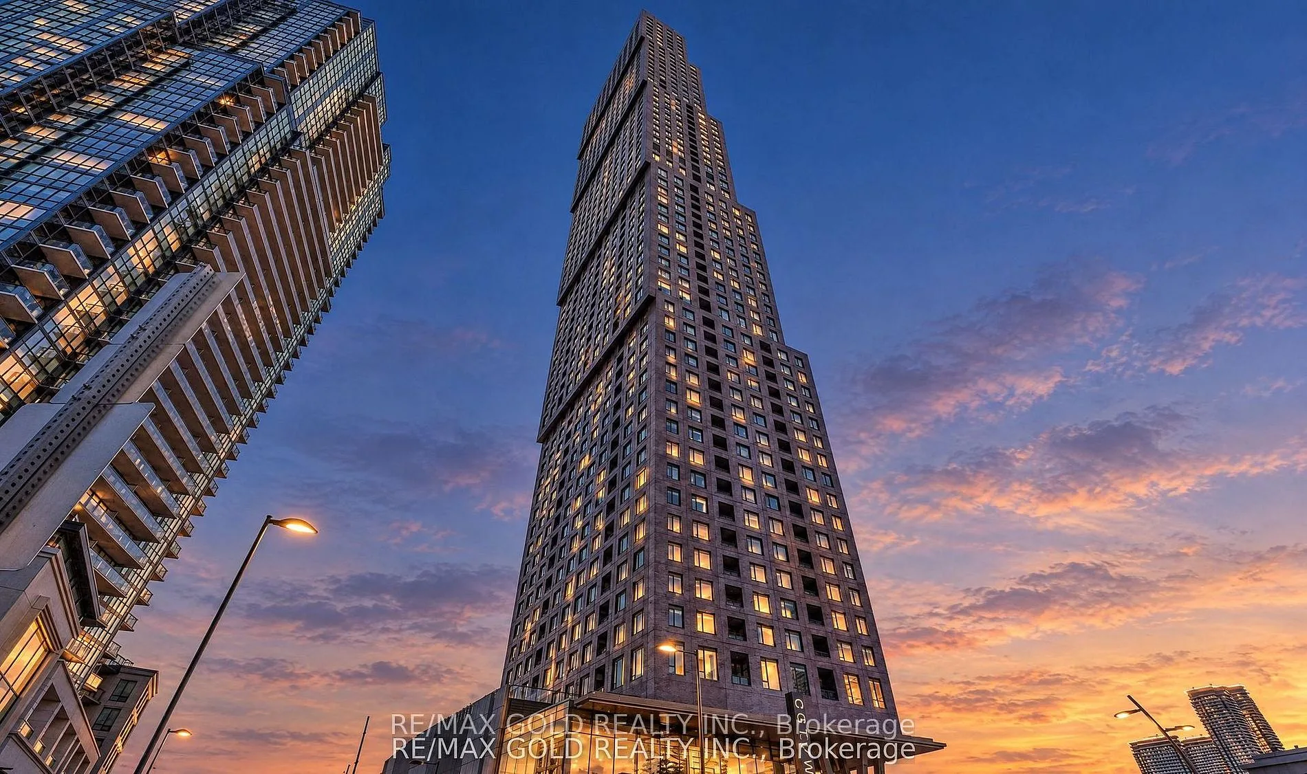 Condo tower rising into a sunset sky
