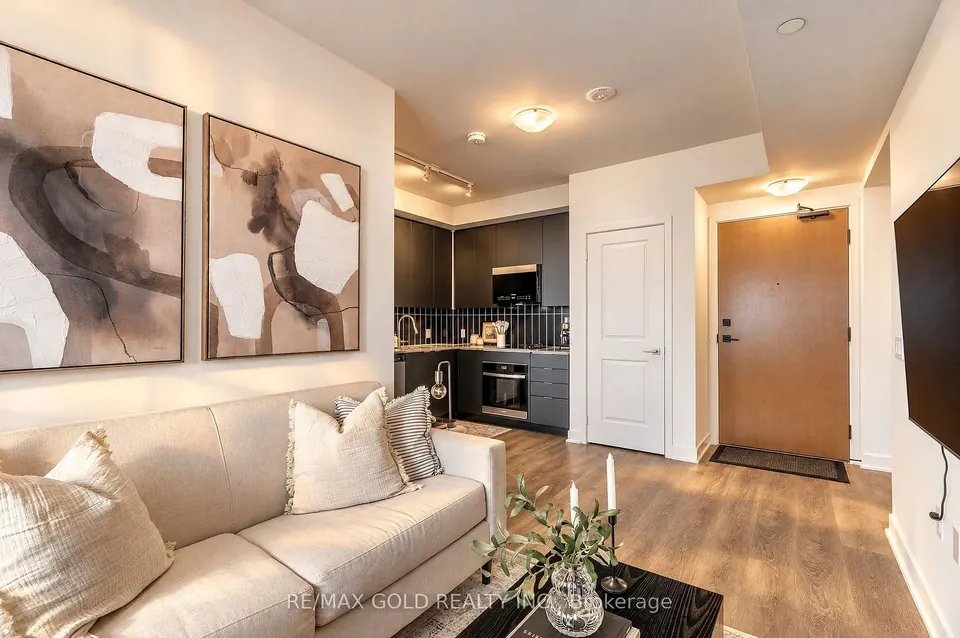 Living room with abstract art and a view to the front door