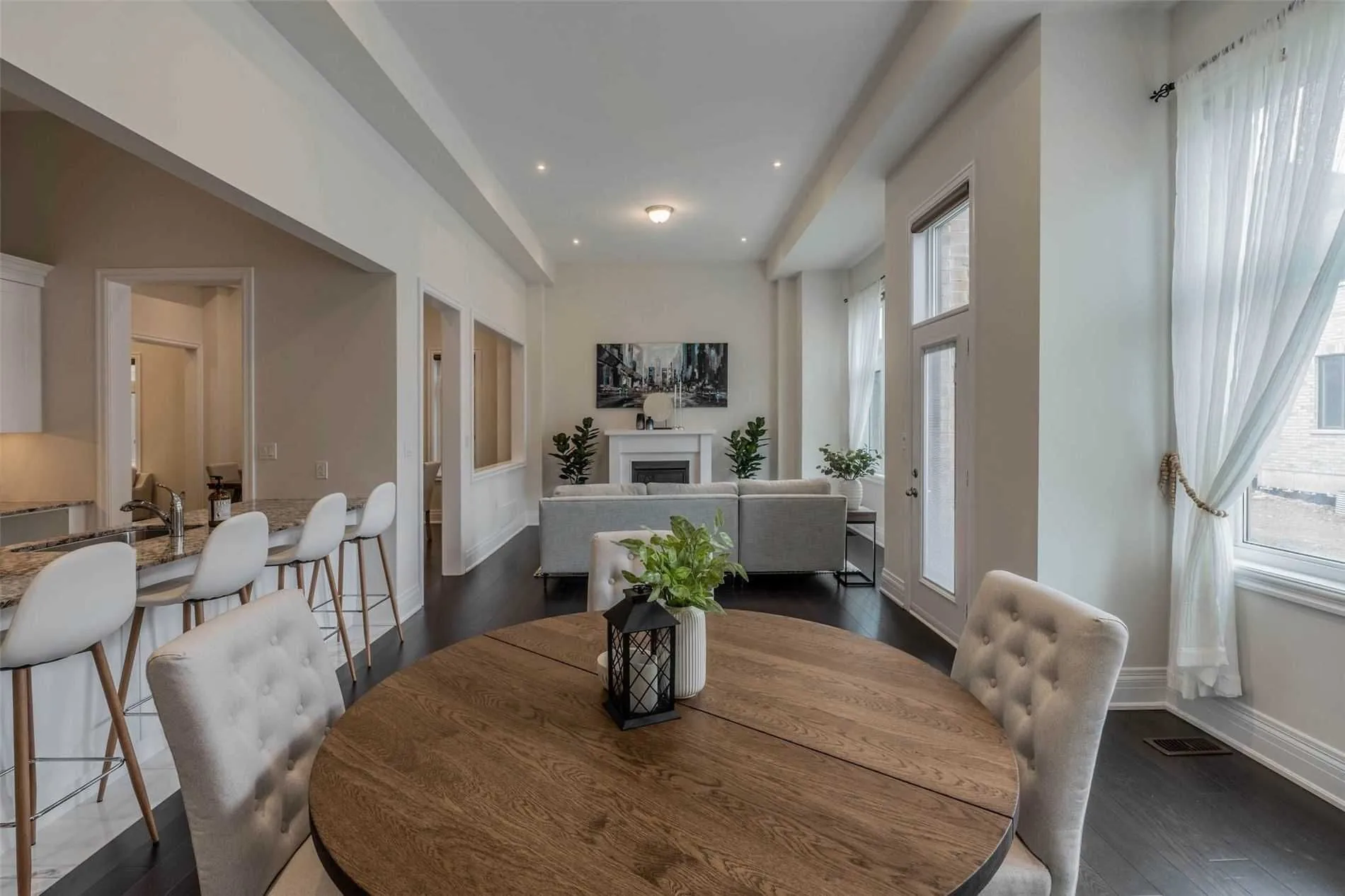 Round dining table in an open main floor with dark hardwood