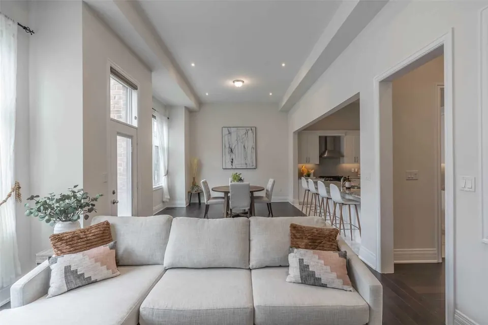 Living room with a large sectional under tall windows