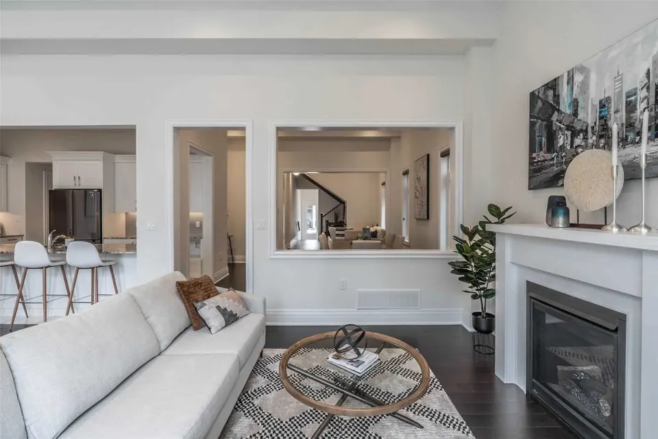 Living room with a fireplace and an opening to the kitchen