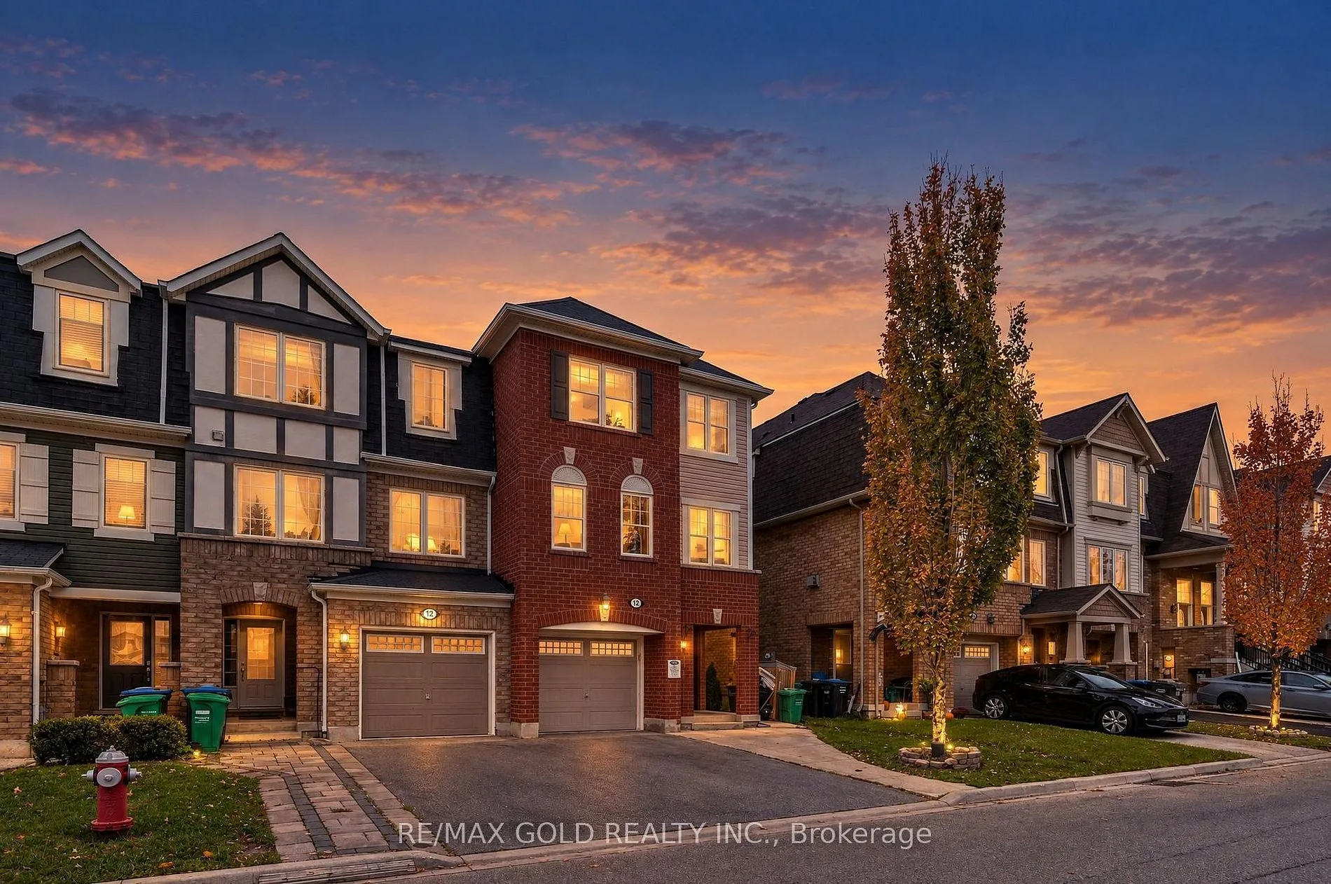 Three-storey townhomes lit up at dusk