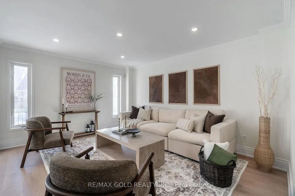 Living room with three framed panels and a cream sofa