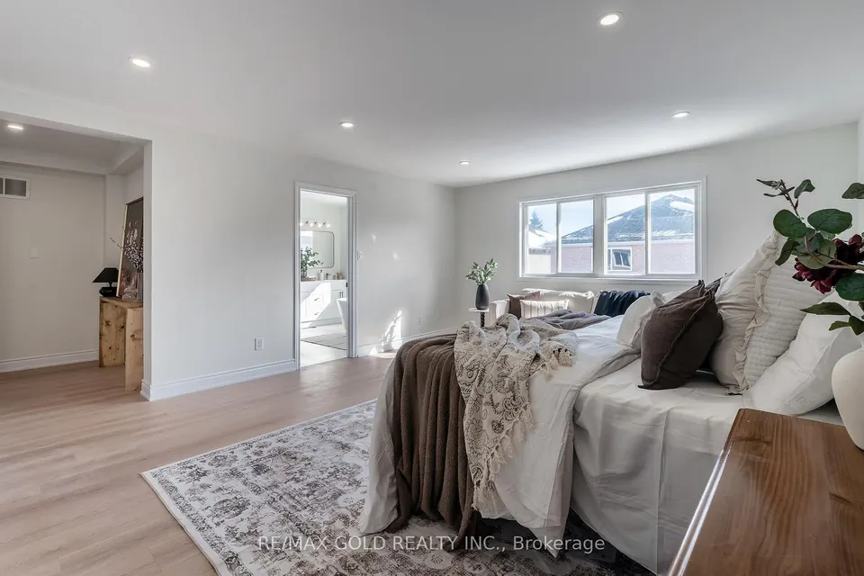 Bedroom with a sitting area and a doorway to the ensuite