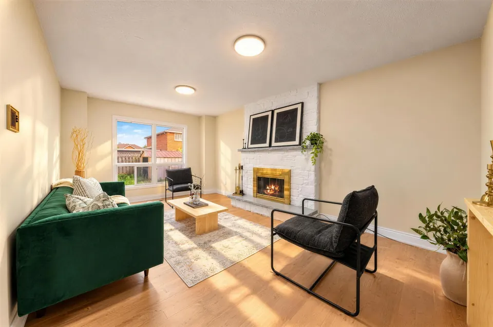 Family room with a green sofa and a fireplace