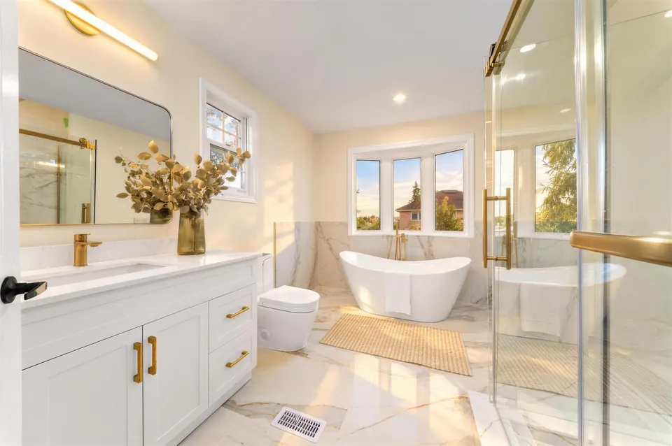 Renovated bathroom with a freestanding tub and a glass shower