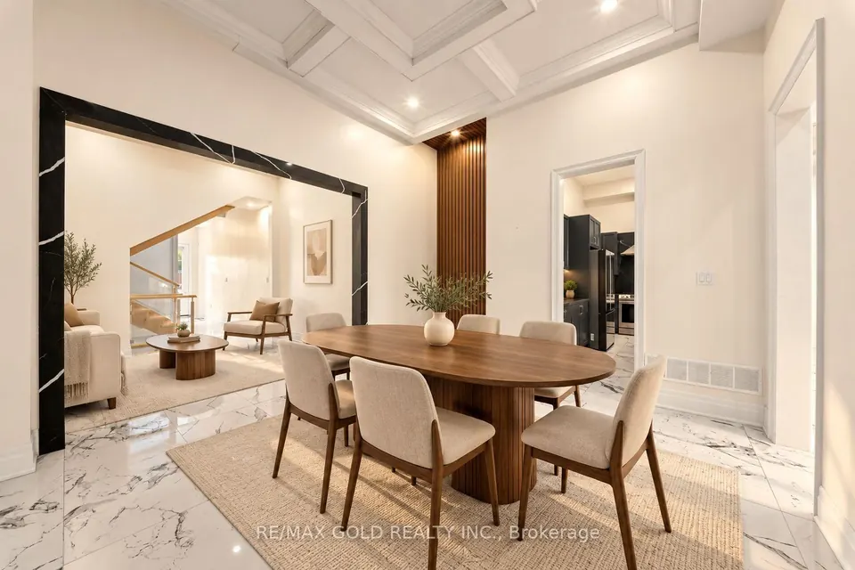 Dining room with a round wood table under a coffered ceiling