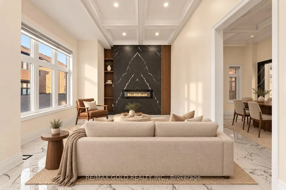 Living room with a marble fireplace wall and coffered ceiling