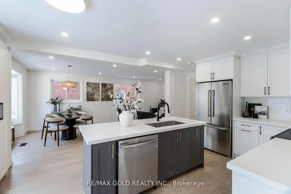 Kitchen with a grey island and white cabinets