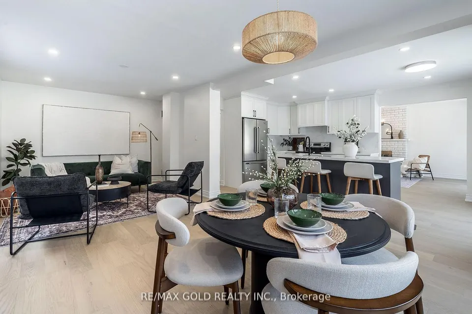 Dining area with a round table set for four, open to the kitchen
