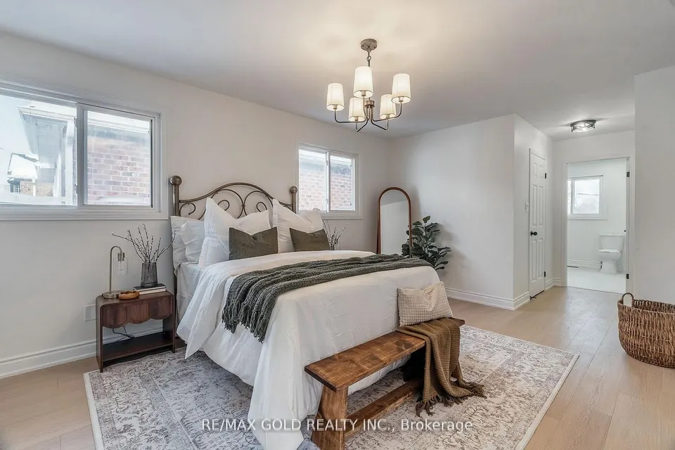 Bedroom with an iron bed frame and a patterned rug