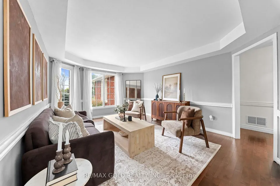 Living room with a dark sofa and soft grey walls