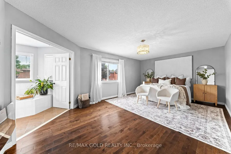 Bedroom with hardwood floors and a bright sitting nook