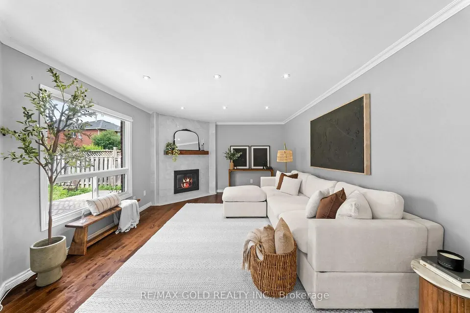 Living room with a white sectional and a fireplace