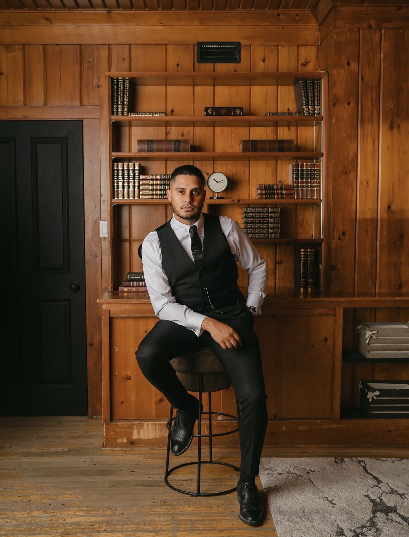 Sam in a wood-panelled library